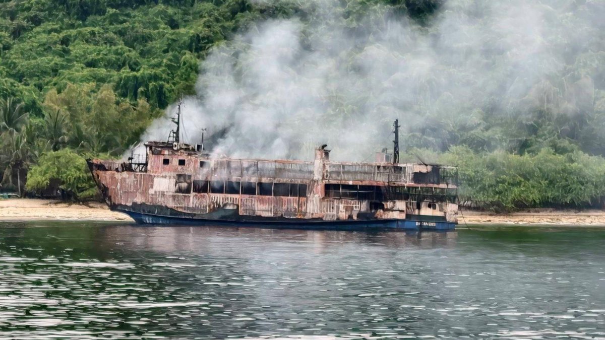 A fresh photo shared by the PCG showing a burned, smoking vessel