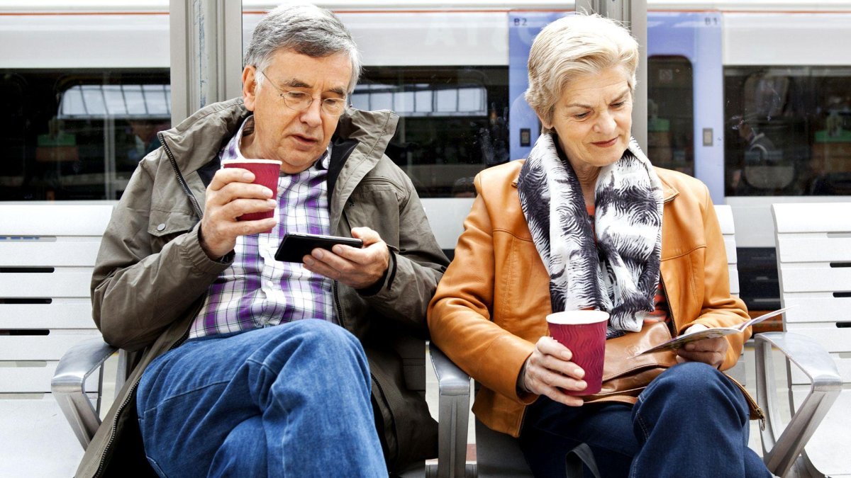 Elderly couple waiting on a train station platform
